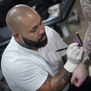 Makoto at work on a traditional Japanese style tattoo at Kaleidoscope Tattoo Studio, Bondi NSW